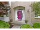 Inviting front entrance with a vibrant purple door, decorative wreath, and potted flowers at 14094 Pecos Ct, Carmel, IN 46033
