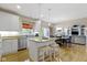 Open kitchen features stainless steel appliances, granite countertops, a breakfast bar, and hardwood floors at 14094 Pecos Ct, Carmel, IN 46033