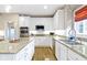 Updated kitchen boasts stainless steel appliances, granite countertops, white cabinets, and hardwood floors at 14094 Pecos Ct, Carmel, IN 46033