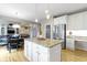 Bright kitchen boasts stainless steel appliances, granite countertops, white cabinets, and hardwood floors at 14094 Pecos Ct, Carmel, IN 46033