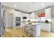 Eat-in kitchen has stainless appliances, granite countertops, a breakfast bar, and hardwood flooring at 14094 Pecos Ct, Carmel, IN 46033