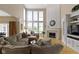 Bright living room featuring a fireplace, and oversized windows with a view at 14094 Pecos Ct, Carmel, IN 46033