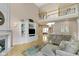 A spacious living room featuring built-in shelving, fireplace, and staircase leading to the second story at 14094 Pecos Ct, Carmel, IN 46033