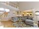 Open-concept living area with hardwood floors, a cozy sectional, and a view of the upper level at 14094 Pecos Ct, Carmel, IN 46033
