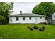 Great backyard with mature trees, green grass, a fire pit and outdoor seating offering plenty of space for recreation at 1431 N Bolton Ave, Indianapolis, IN 46219