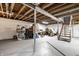 Spacious basement with exposed ceiling, and stairs at 1431 N Bolton Ave, Indianapolis, IN 46219