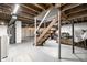 Spacious basement with exposed ceiling, and stairs at 1431 N Bolton Ave, Indianapolis, IN 46219