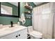 Stylish bathroom featuring green wall, sink, and toilet at 1431 N Bolton Ave, Indianapolis, IN 46219