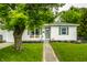 Charming single-story home with a well-manicured lawn and welcoming front porch at 1431 N Bolton Ave, Indianapolis, IN 46219