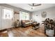 Cozy living room with wood floors, neutral walls, and comfortable seating area at 1431 N Bolton Ave, Indianapolis, IN 46219
