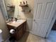 Bathroom features a vanity with sink, mirror, shelving, and convenient toilet paper holder at 160 Rambling Rd, Greenfield, IN 46140