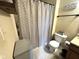Bathroom with a toilet, tub, shower curtain, and decorative sign encouraging hand washing at 160 Rambling Rd, Greenfield, IN 46140