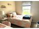 Cozy bedroom with patterned bedspread, window with natural light, and unique decorative shelving at 160 Rambling Rd, Greenfield, IN 46140