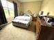 Bedroom with carpet, large window, upholstered headboard, and wooden dresser for storage at 160 Rambling Rd, Greenfield, IN 46140