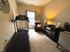 Bonus room features a treadmill, comfortable seating, and an entertainment center with a fireplace at 160 Rambling Rd, Greenfield, IN 46140