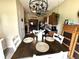 Dining room with modern lighting, dining table set for four, and open view to kitchen at 160 Rambling Rd, Greenfield, IN 46140
