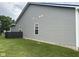 Side exterior view of a home with gray siding and a well-manicured lawn, providing a neat and clean appearance at 160 Rambling Rd, Greenfield, IN 46140