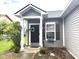 Charming home entrance with gray siding, a welcoming front door, and landscaped garden bed at 160 Rambling Rd, Greenfield, IN 46140