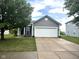 Charming single-story home featuring a two-car garage, neat landscaping, and a classic gray exterior at 160 Rambling Rd, Greenfield, IN 46140