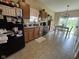 Well-lit kitchen features tile flooring, ample counter space, and an adjacent dining area with sliding glass door at 160 Rambling Rd, Greenfield, IN 46140