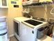 Convenient laundry room with modern washer and dryer, shelving units for storage, and ample counter space at 160 Rambling Rd, Greenfield, IN 46140