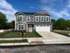 Charming two-story home with gray siding, white trim, an attached two car garage, and a neatly manicured lawn at 1684 Bayberry Dr, Greenfield, IN 46140