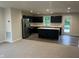 Modern kitchen featuring sleek black cabinetry, stainless steel appliances, and a center island with sink at 1684 Bayberry Dr, Greenfield, IN 46140