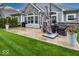 A beautiful back patio with outdoor seating, a grill, and well-maintained green grass at 1701 Summerwood Blvd, Greenfield, IN 46140