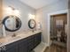 Bathroom featuring a double vanity, decorative mirrors, and a toilet room at 1701 Summerwood Blvd, Greenfield, IN 46140