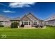 A lovely exterior view of the home showing the patio, landscaping and attractive architectural design at 1701 Summerwood Blvd, Greenfield, IN 46140