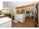 Open concept kitchen with an island bar, stainless steel appliances, and hardwood floors at 1701 Summerwood Blvd, Greenfield, IN 46140