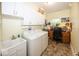 This laundry room offers a sink, washer, dryer, workspace, and upper cabinets for storage at 1701 Summerwood Blvd, Greenfield, IN 46140
