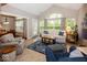 Cozy and well-lit living room with comfortable seating and an open archway to the dining area at 1701 Summerwood Blvd, Greenfield, IN 46140