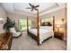 Spacious main bedroom featuring a four-poster bed, ceiling fan and natural lighting at 1701 Summerwood Blvd, Greenfield, IN 46140
