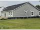 Exterior side and back view of a gray home with black roof and grass backyard at 1730 Juniper Ln, Greenfield, IN 46140