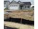 Charming gray single-story home with a two-car garage and undergoing landscaping at 1730 Juniper Ln, Greenfield, IN 46140