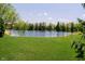 Beautiful backyard with lush green lawn and a tranquil water view at 194 Waterford Ct, Avon, IN 46123