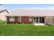 Brick home with sliding glass doors that lead to a brick patio and lush green lawn at 194 Waterford Ct, Avon, IN 46123