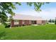 Brick home featuring a well-maintained lawn, brick patio and beautiful water view at 194 Waterford Ct, Avon, IN 46123