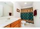 Bright bathroom with a shower-tub combo, patterned curtain and towel rack at 194 Waterford Ct, Avon, IN 46123