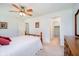Bedroom featuring neutral carpet, ceiling fan, and views into the hallway and walk-in closet at 194 Waterford Ct, Avon, IN 46123