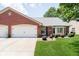 Charming brick home featuring an attached garage and beautifully maintained front lawn at 194 Waterford Ct, Avon, IN 46123