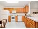 Bright kitchen features white appliances and beautiful wooden cabinetry for ample storage at 194 Waterford Ct, Avon, IN 46123
