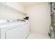 Well-lit laundry area equipped with a washer, dryer, shelving, and utility appliances at 194 Waterford Ct, Avon, IN 46123