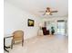 Well-lit living room featuring a ceiling fan, neutral carpet, and access to the outdoors at 194 Waterford Ct, Avon, IN 46123