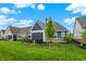 Well-maintained backyard with green grass, a patio, and mature trees, offering a peaceful outdoor space at 20010 Prescott Pl, Westfield, IN 46074