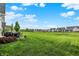 Expansive backyard with lush green grass, patio furniture, and views of neighborhood homes at 20010 Prescott Pl, Westfield, IN 46074