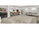 Expansive basement space with gray carpeting, a stylish bar area, and a ping pong table for recreation at 20010 Prescott Pl, Westfield, IN 46074
