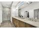 Bathroom featuring double vanity, a marble tile shower and a large framed mirror at 20010 Prescott Pl, Westfield, IN 46074