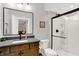 Modern bathroom features sleek black framed shower and mirror, contemporary fixtures, and neutral finishes at 20010 Prescott Pl, Westfield, IN 46074